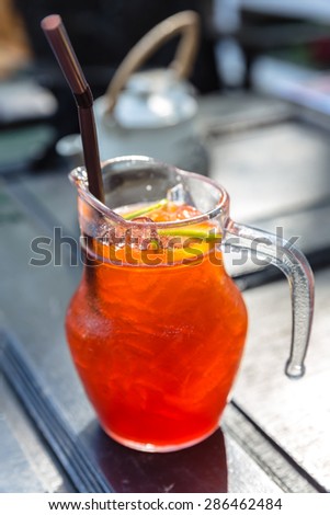 Iced tea in the pitcher. A jug of cold tea mixed with lemonade