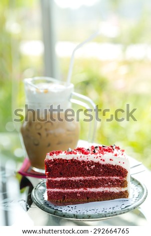 one slice of red velvet cake in front of the whole dessert, red velvet cake