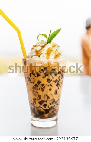 Glass of Ice milk tea with Whipped Cream