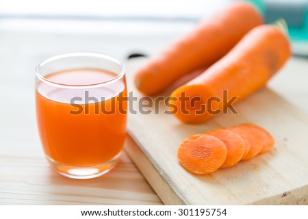 Carrot juice and slices of carrot, glasses of carrot juice and fresh carrots