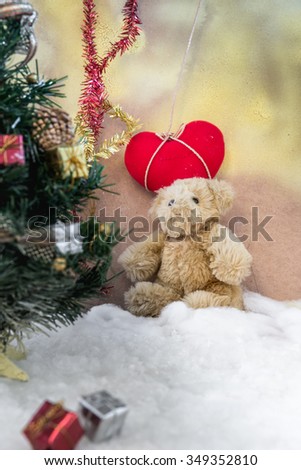 Teddy bear is sitting on snow background-concept christmas and new year
