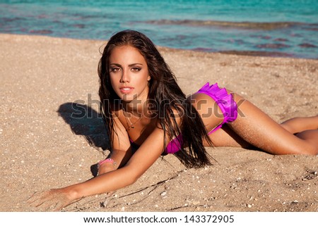 sexy young woman lying on sand , Summer vocation at resort Island. Outdoor photography. horizontal shot.