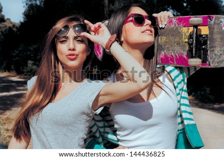 Two Young Friends Holding A Skateboard And Sending A Kisses . Summer Style Pictures.
