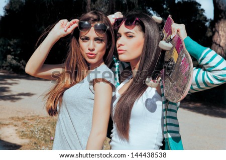 Two Young Friends Holding A Skateboard And Sending A Kisses . Summer Style Pictures.