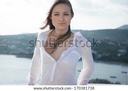 Attractive fashion woman in elegant clothes. outdoors shot by the sea