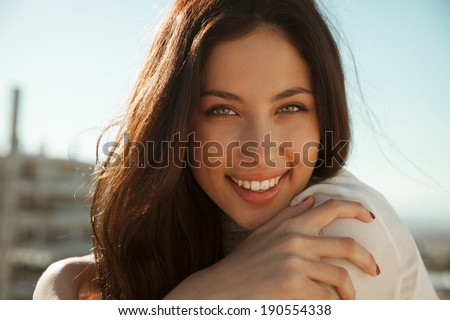 Wonderful smiling woman with a lovely look and bright make up. Natural young beauty. horizontal shot. outdoors