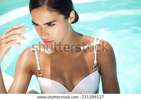 Young woman beauty portrait in water. Summer style. Horizontal shot.