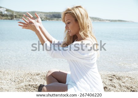 Woman playing with sand.  summer style, outdoors shot. horizontal