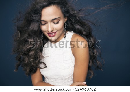 beautiful young woman with shine hair and bright makeup smiling. Make up and cosmetics concept. studio shot, horizontal