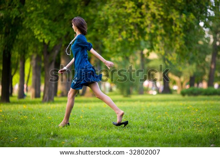 Hurrying Woman Walking Fast Throung Park On A Date Stock Photo