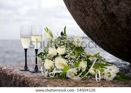 stock photo wedding bouquet and two champagne glasses outdoors