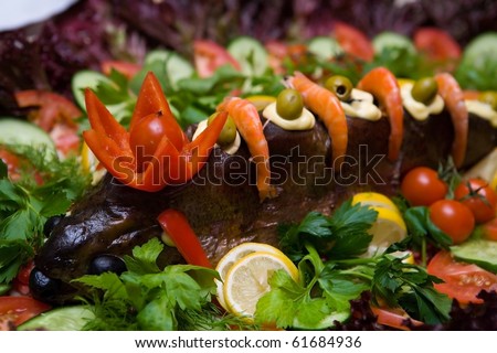 baked fish full body on plate in restaurant