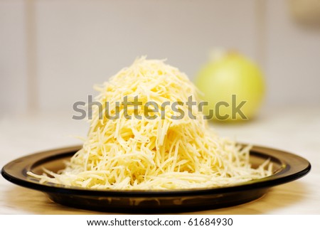 grated cheese on plate on kitchen table
