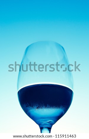 wine glass with water against a blue sky in the evening