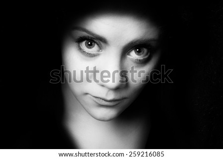 bigeye shy young woman who looks straight into the camera