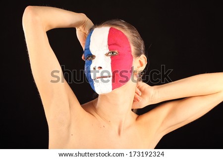 Football fan with face painted in France color on black background