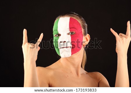 Football fan with face painted in Italy color on black background