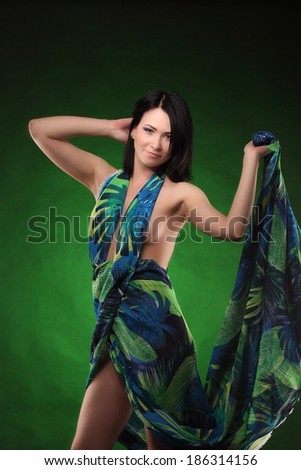 Brown head beauty girl in green dress show her body on green and black background