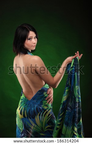 Brown head beauty girl in green dress show her body on green and black background