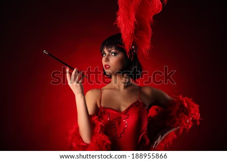 Burlesque dancer with red plumage and red short dress, black and red background