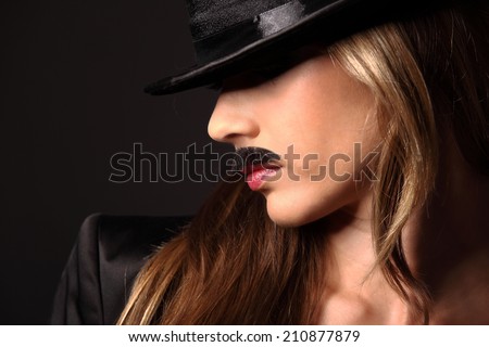 Blonde girl with mustache looking at camera, look like a man