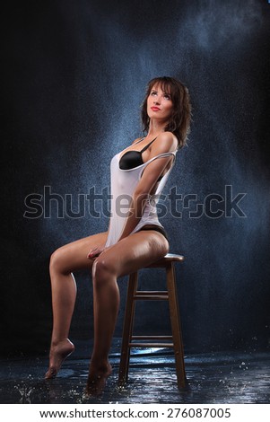 Young sexy nude woman wet sitting on chair. Water studio photo. fresh