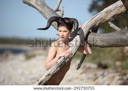 The beautiful young girl with horns like devil or angel outdoor