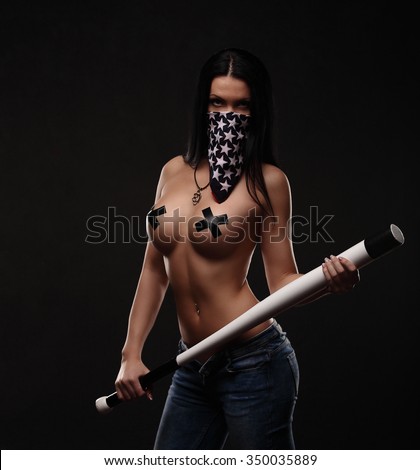 portrait of sexy topless girl with weapon and american flag studio