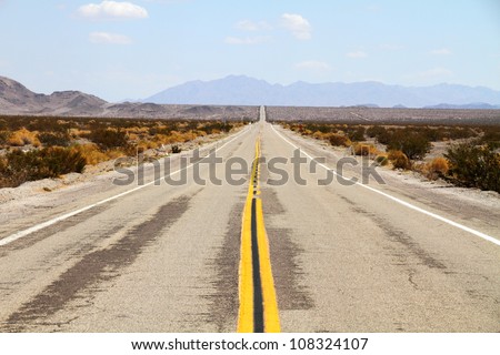 Long desert highway leading into Mojave Desert