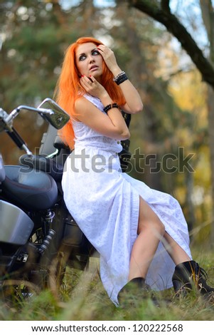 Redhead woman on motorcycle