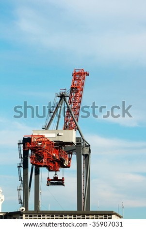Sea containers crane on a blue sky