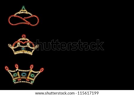 Three Kings Crowns against black background with copy space