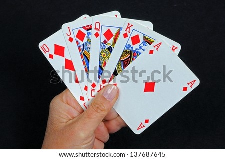 Royal flush poker hand in the diamond suit against a black background.