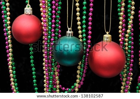 Red and green plastic Christmas baubles with colourful beads, England, UK, Western Europe.