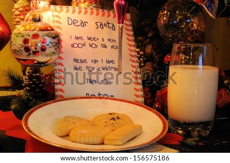 Dear Santa letter, milk and cookies under Christmas tree.