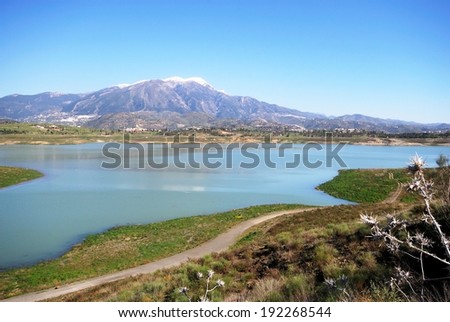 View of Lake Vinuela with snow capped mountains to the rear, La Vinuela, Costa del Sol, Malaga Province, Andalusia, Spain, Western Europe.