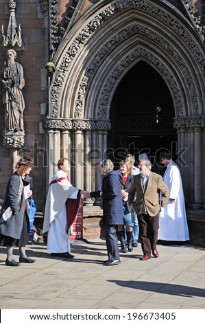 LICHFIELD, UNITED KINGDOM - MARCH 9, 2014 - Clergymen greeting members of the congregation outside the Cathedral West Front door, Lichfield, Staffordshire, England, UK, Western Europe, March 9, 2014.