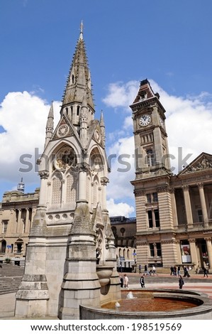 BIRMINGHAM, UK - MAY 14, 2014 - Chamberlain memorial in Chamberlain Square with the clock tower of Birmingham museum and art gallery to the rear, Birmingham, UK, May 14, 2014.