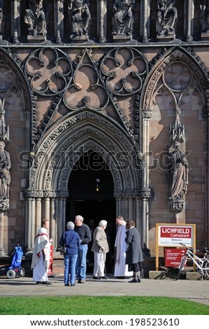 LICHFIELD, UNITED KINGDOM - MARCH 9, 2014 - Clergymen greeting members of the congregation outside the Cathedral West Front door, Lichfield, Staffordshire, England, UK, Western Europe, March 9, 2014.