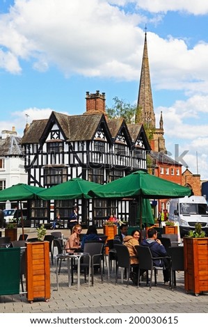 HEREFORD, UK - JUNE 5, 2014 - Pavement cafe in the shopping street with the High House in High Town (Built in 1621) to the rear, Hereford, Herefordshire, England, UK, Western Europe, June 5, 2014.