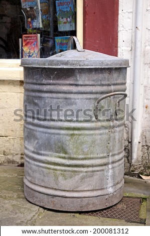 LEOMINSTER, UNITED KINGDOM - JUNE 5, 2014 - An old tin dustbin outside a shop along School Lane, Leominster, Herefordshire, England, UK, Western Europe, June 5, 2014.