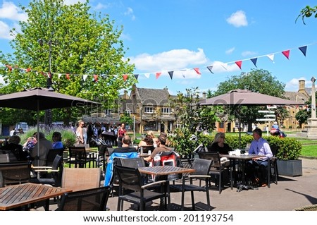 BROADWAY, UNITED KINGDOM - JUNE 12, 2014 - People relaxing at the cafe outside the Broadway Hotel, Broadway, Cotswolds, Worcestershire, England, UK, Western Europe, June 12, 2014.