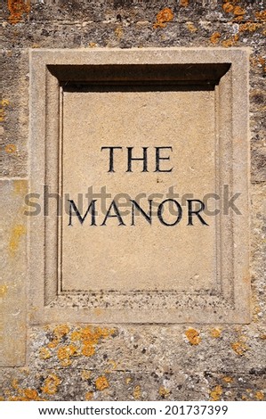 The Manor sign carved in Cotswold stone, Bourton on the Water, Gloucestershire, England, UK, Western Europe.