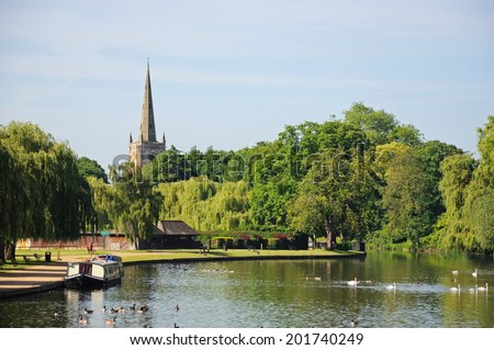 STRATFORD-UPON-AVON, UK - JUNE 12, 2014 - View along the River Avon towards the Holy Trinity Church, Stratford-upon-Avon, Warwickshire, England, UK, Western Europe, June 12, 2014.