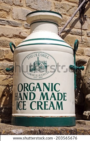 LOWER SLAUGHTER, UK - JUNE 12, 2014 - Organic hand made ice cream painted onto an old milk churn outside the entrance to the Old Mill, Lower Slaughter, Gloucestershire, England, UK, June 12, 2014.