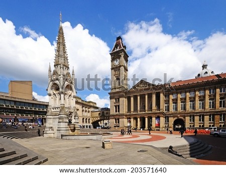 BIRMINGHAM, UK - MAY 14, 2014 - Chamberlain memorial in Chamberlain Square with the clock tower of Birmingham museum and art gallery to the rear, Birmingham, West Midlands, England, UK, May 14, 2014.