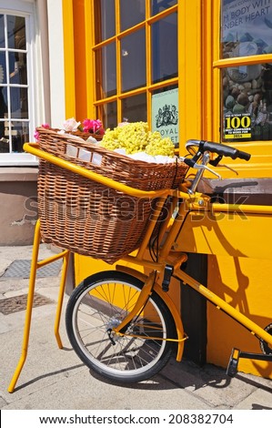 STRATFORD-UPON-AVON, UK - MAY 18, 2014 - Bike with wicker basket full of flowers along Bridge Street, Stratford-Upon-Avon, Warwickshire, England, UK, Western Europe, May 18, 2014.