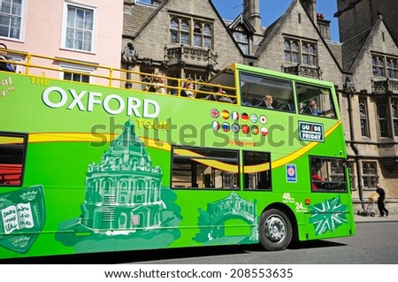 OXFORD, UNITED KINGDOM - JUNE 17, 2014 - Green open topped Oxford tour bus along High Street, Oxford, Oxfordshire, England, UK, Western Europe, June 14, 2014.