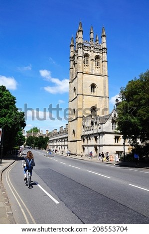 OXFORD, UNITED KINGDOM - JUNE 17, 2014 - View of Magdalen College along High Street with a cyclist in the foreground, Oxford, Oxfordshire, England, UK, Western Europe, June 17, 2014.