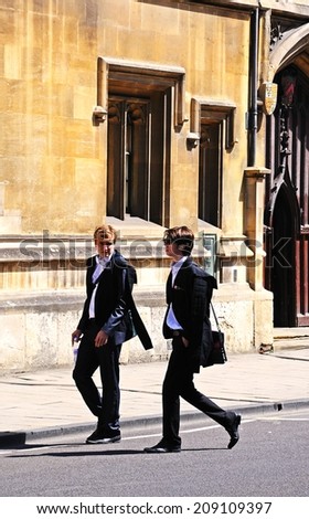 Oxford, United Kingdom - June 17, 2014 - Students walking along the High Street wearing academic dress, Oxford, Oxfordshire, England, UK, Western Europe, June 17, 2014.